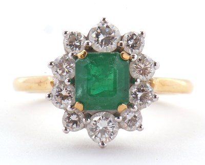 Lot 74 - An 18ct emerald and diamond ring, the central...
