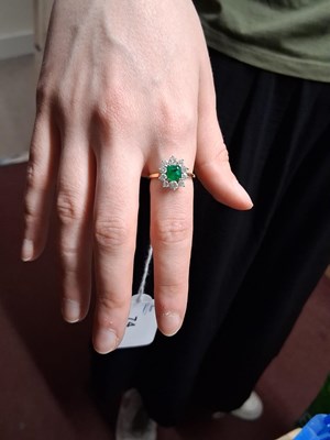 Lot 74 - An 18ct emerald and diamond ring, the central...