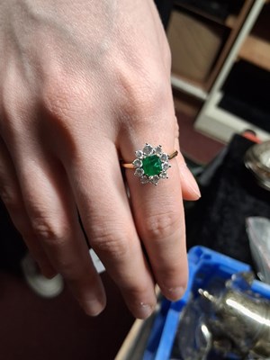Lot 74 - An 18ct emerald and diamond ring, the central...