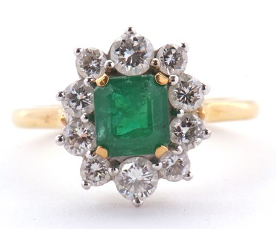 Lot 74 - An 18ct emerald and diamond ring, the central...