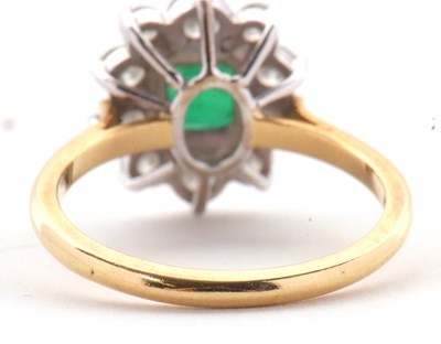 Lot 74 - An 18ct emerald and diamond ring, the central...