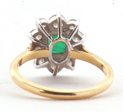Lot 74 - An 18ct emerald and diamond ring, the central...