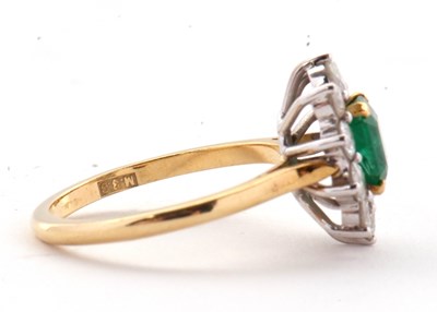 Lot 74 - An 18ct emerald and diamond ring, the central...