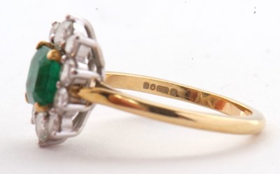 Lot 74 - An 18ct emerald and diamond ring, the central...