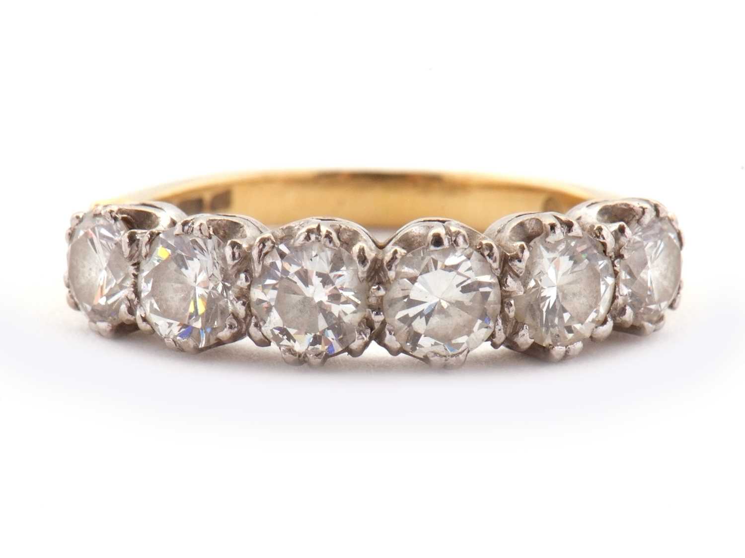 Lot 79 - An 18ct six stone diamond ring, the six round...
