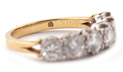 Lot 79 - An 18ct six stone diamond ring, the six round...