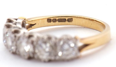Lot 79 - An 18ct six stone diamond ring, the six round...