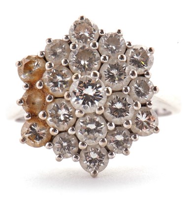 Lot 85 - An 18ct diamond cluster ring, set with round...