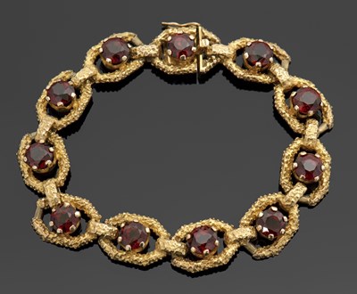 Lot 286 - A 9ct garnet bracelet, the textured links set...