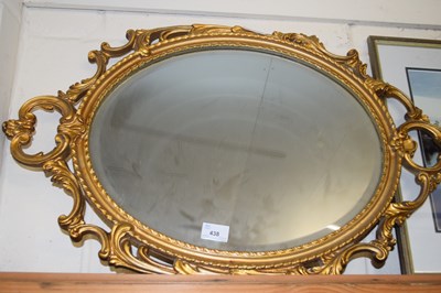 Lot 438 - OVAL BEVELLED WALL MIRROR IN A GILT FINISH...