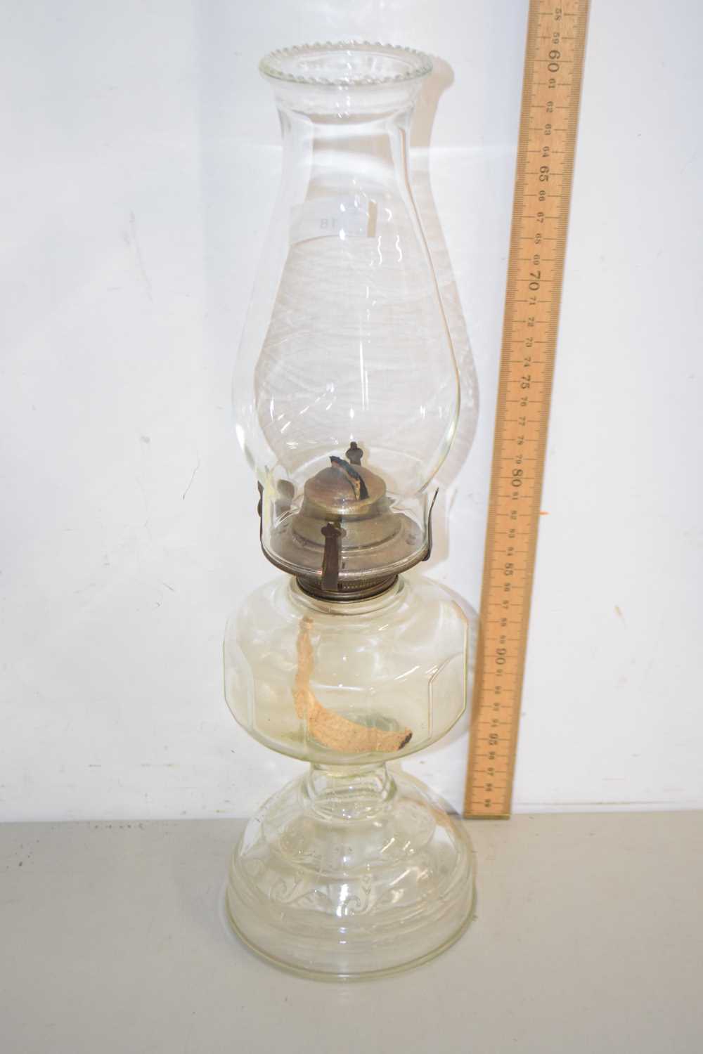 Lot 18 - A clear glass oil lamp