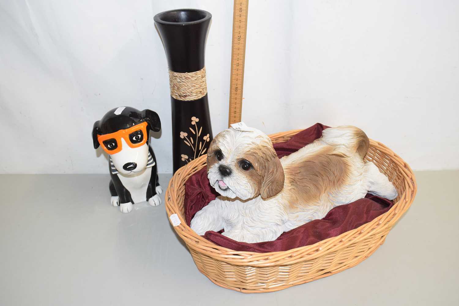 Lot 23 - A resin model dog in basket together with a...