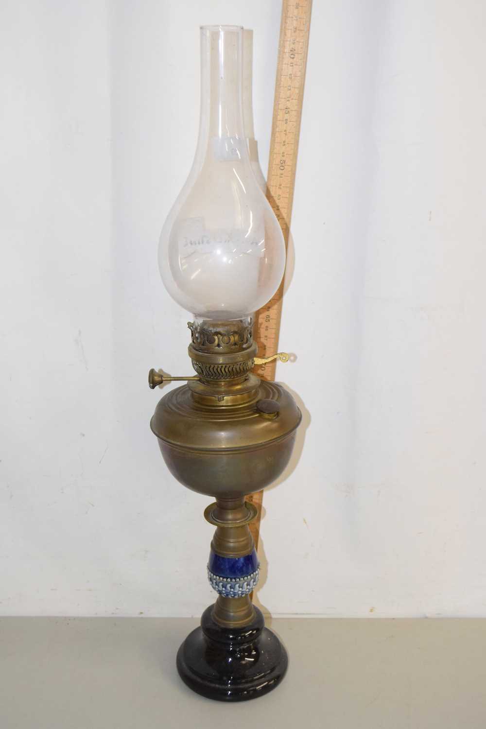 Lot 29 - A brass based oil lamp