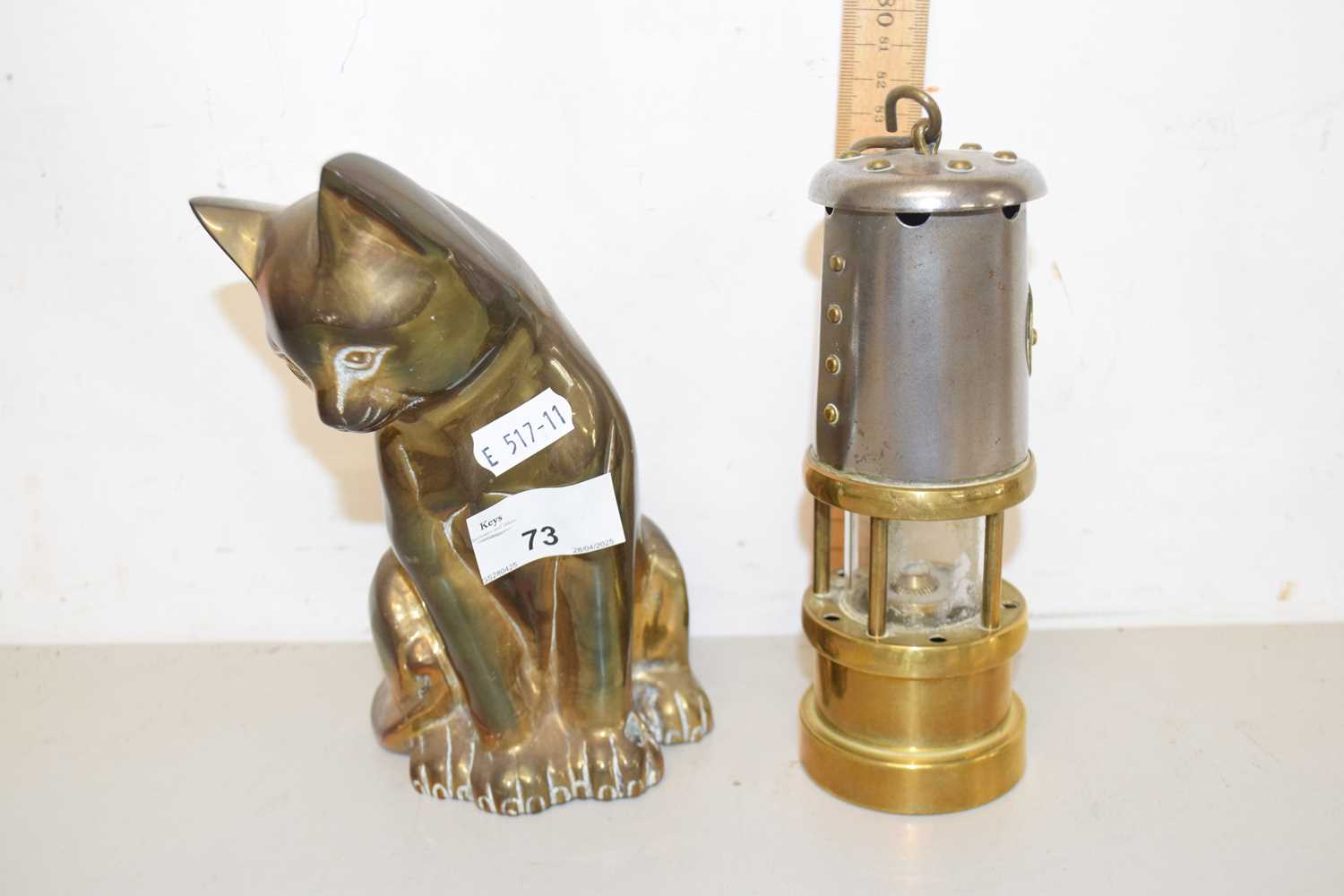 Lot 73 - A brass model of a cat and a reproduction...