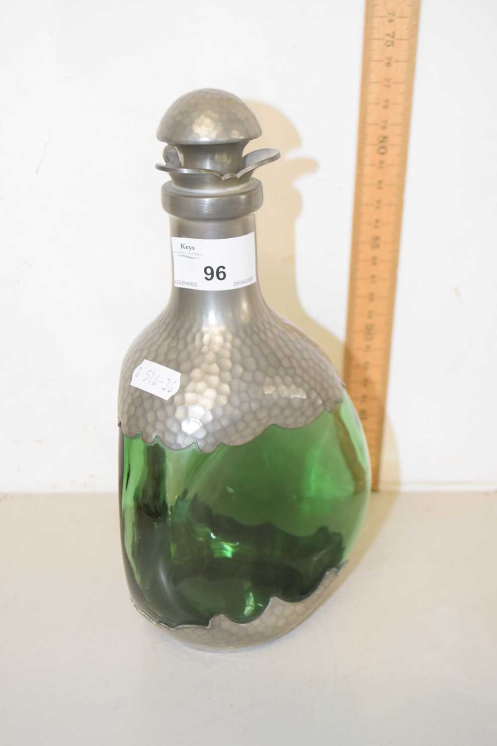 Lot 96 - A pewter mounted green glass dimple decanter
