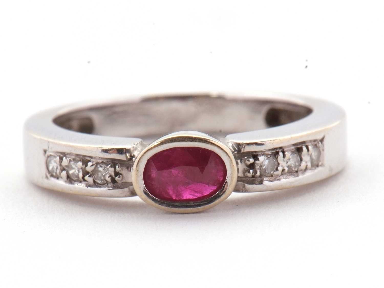 Lot 28 - An 18ct ruby and diamond ring, the central...