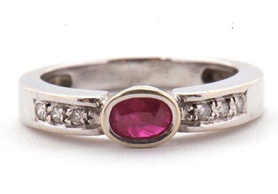 Lot 28 - An 18ct ruby and diamond ring, the central...
