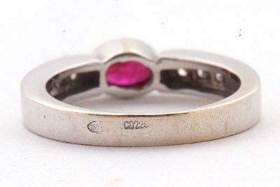 Lot 28 - An 18ct ruby and diamond ring, the central...