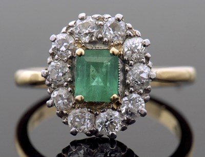 Lot 302 - Emerald and diamond cluster ring, the stepped...