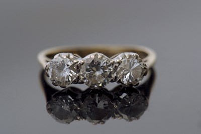 Lot 304 - Three stone diamond ring set with three...
