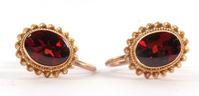 Lot 95 - A pair of garnet earrings, the oval collet...