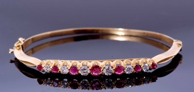 Lot 323 - 18ct gold ruby and diamond hinged bracelet,...