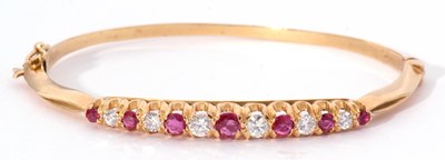 Lot 323 - 18ct gold ruby and diamond hinged bracelet,...