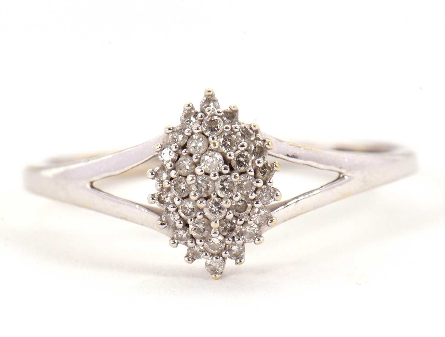 Lot 2 - A diamond cluster ring, the marquise shape...