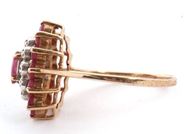 Lot 9 - A 9ct ruby and diamond cluster ring, the oval...