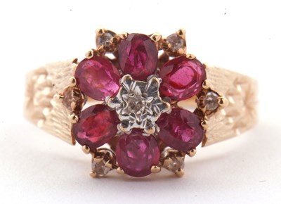 Lot 14 - A 9ct ruby and diamond ring, the central round...