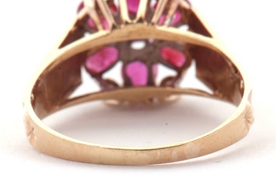 Lot 14 - A 9ct ruby and diamond ring, the central round...