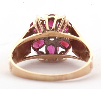Lot 14 - A 9ct ruby and diamond ring, the central round...