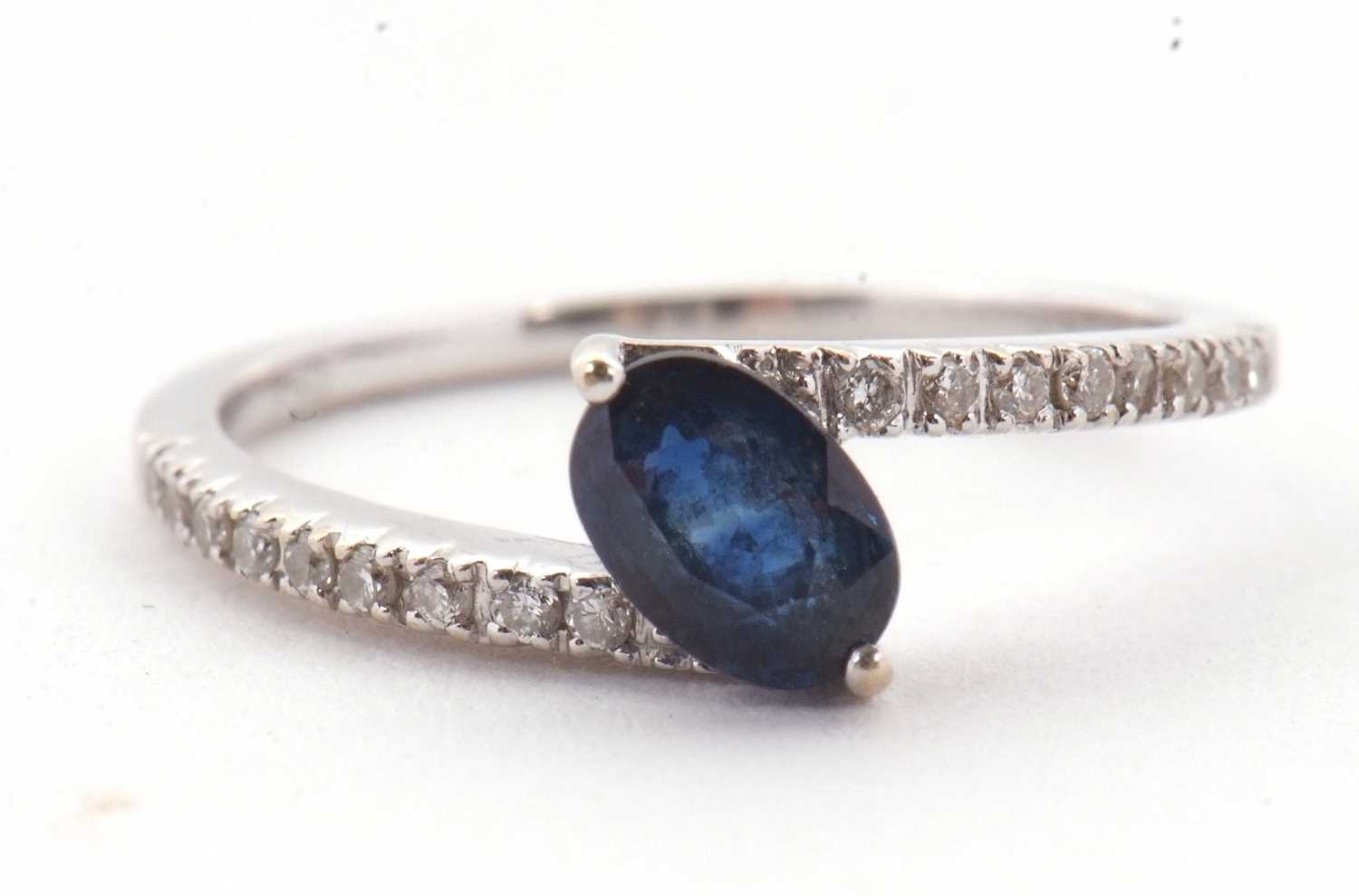 Lot 16 - A sapphire and diamond crossover ring, the...