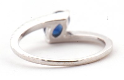 Lot 16 - A sapphire and diamond crossover ring, the...