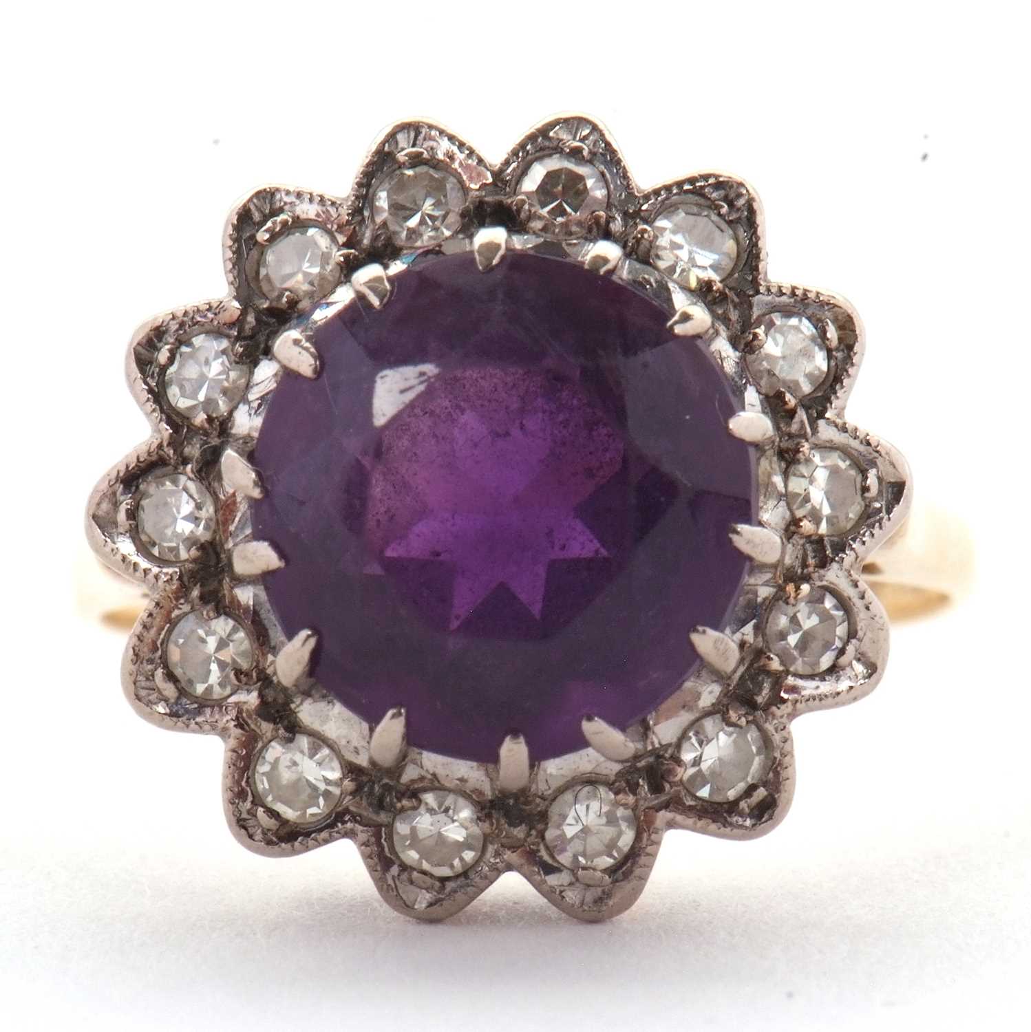 Lot 84 - An 18ct amethyst and diamond ring, the round...
