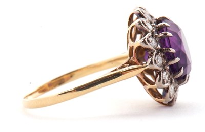 Lot 84 - An 18ct amethyst and diamond ring, the round...
