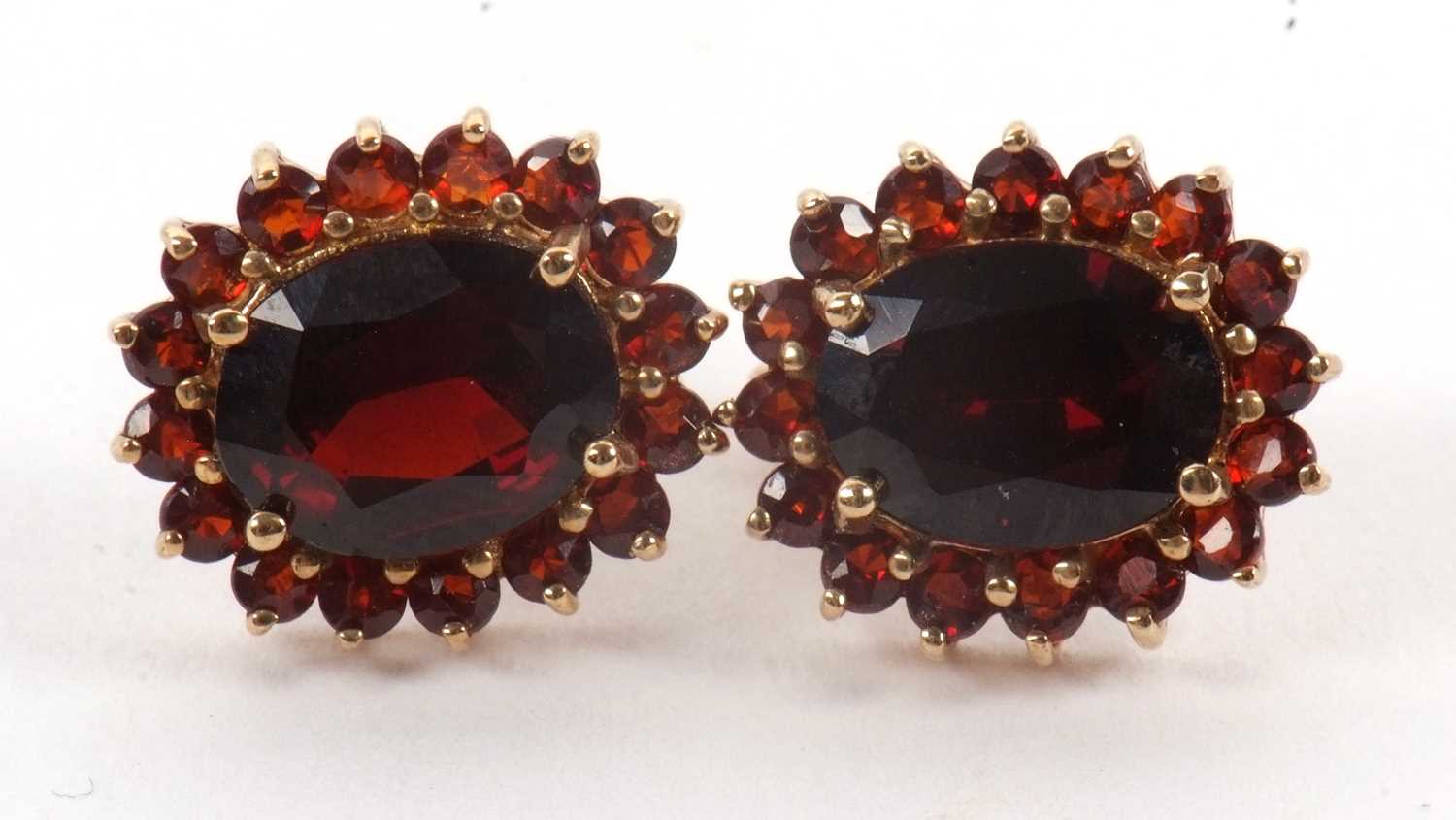 Lot 94 - A pair of 9ct garnet earrings, the oval...