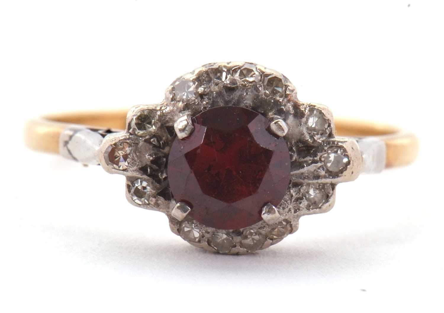 Lot 21 - A garnet and diamond ring, the central round...