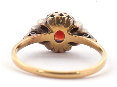 Lot 21 - A garnet and diamond ring, the central round...