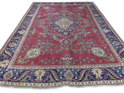 Lot 403 - Large Iranian wool floor rug decorated with...