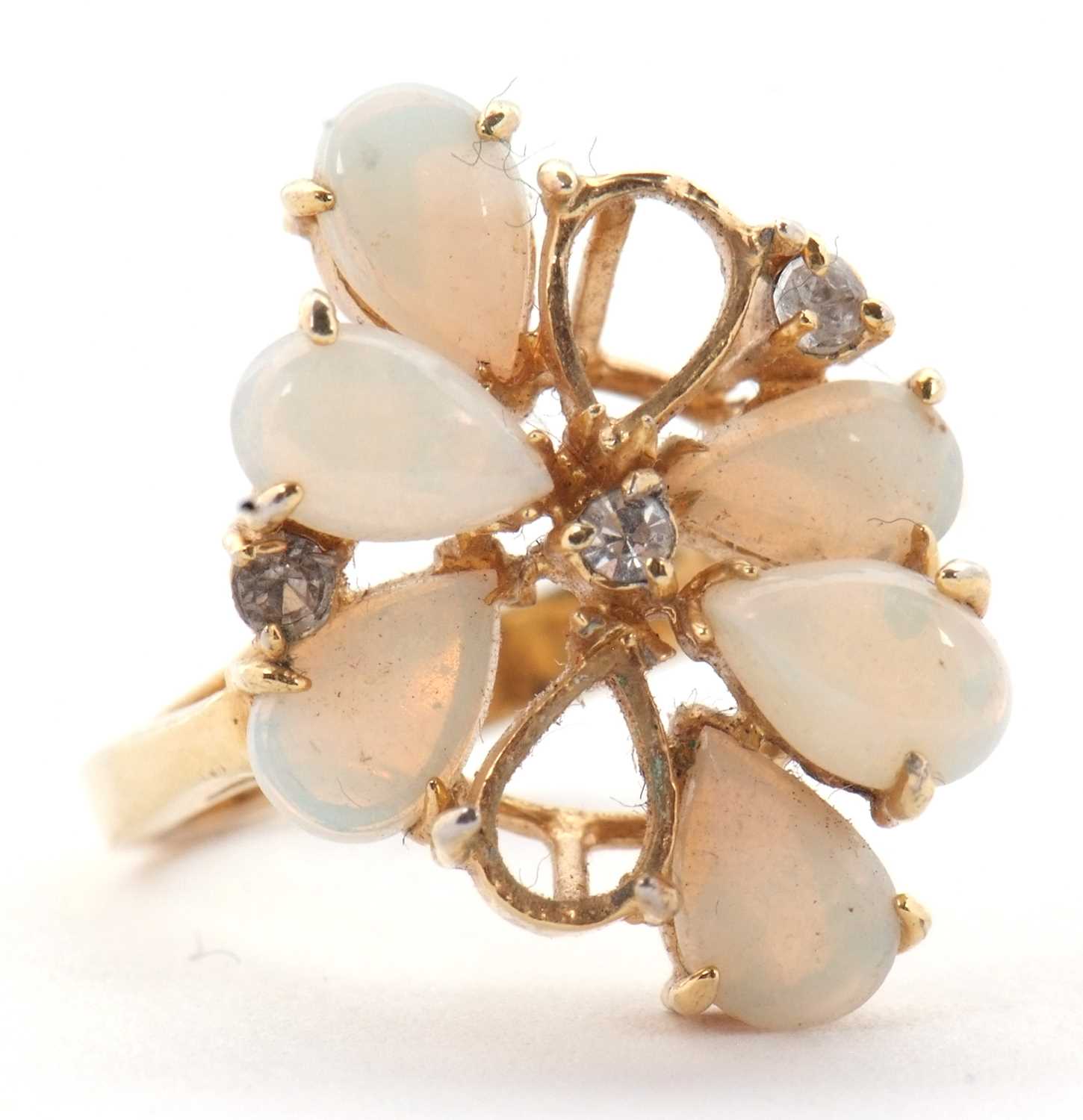 Lot 23 - An opal cluster ring, the pear shape opal...