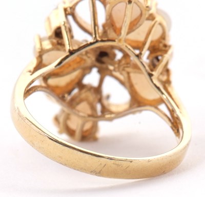Lot 23 - An opal cluster ring, the pear shape opal...