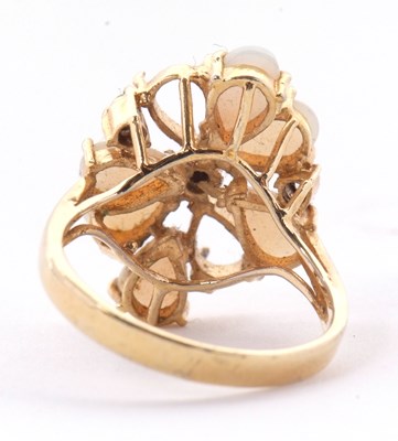 Lot 23 - An opal cluster ring, the pear shape opal...