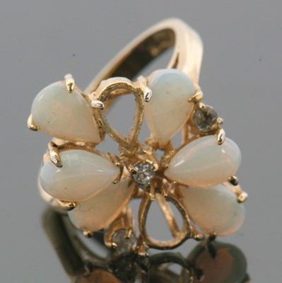 Lot 23 - An opal cluster ring, the pear shape opal...