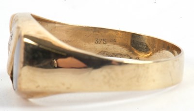 Lot 61 - A gentleman's onyx and diamond ring, set with...