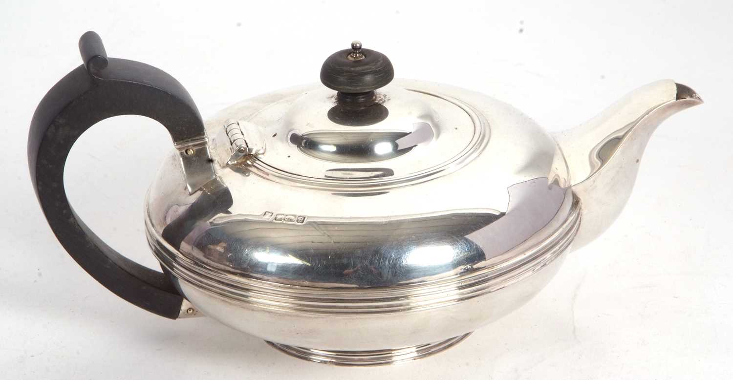 Lot 106 - An Edwardian silver teapot of compressed...