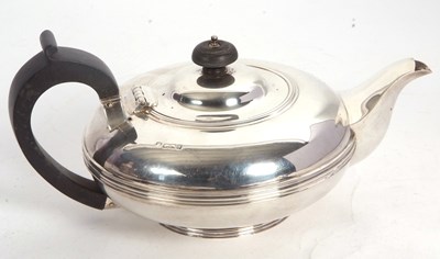 Lot 106 - An Edwardian silver teapot of compressed...
