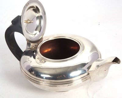 Lot 106 - An Edwardian silver teapot of compressed...