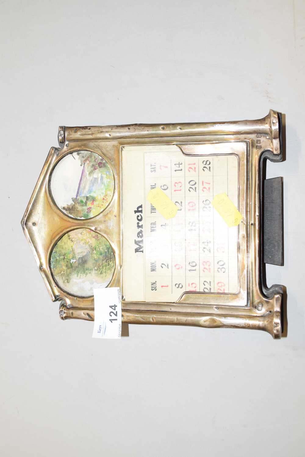 Lot 124 - A calendar in brass frame