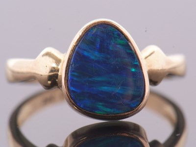 Lot 38 - A 14ct opal doublet ring, the asymetric opal...